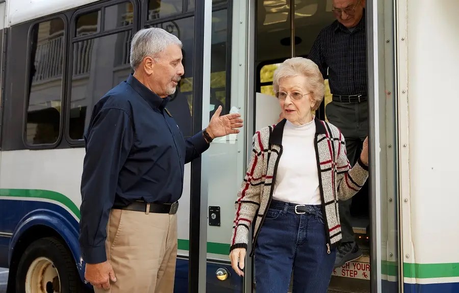 Image of senior citizens getting off of bus